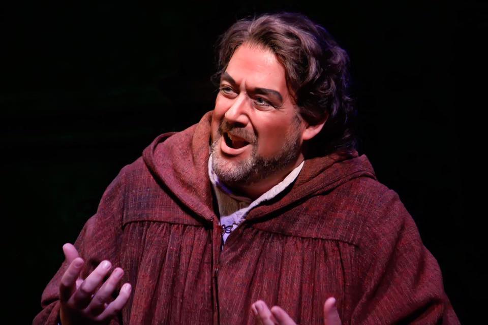 Andrew Stuckey singing on stage